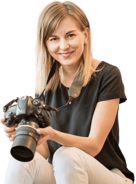smiley-woman-sitting-chair-with-camera-photo-removebg 2